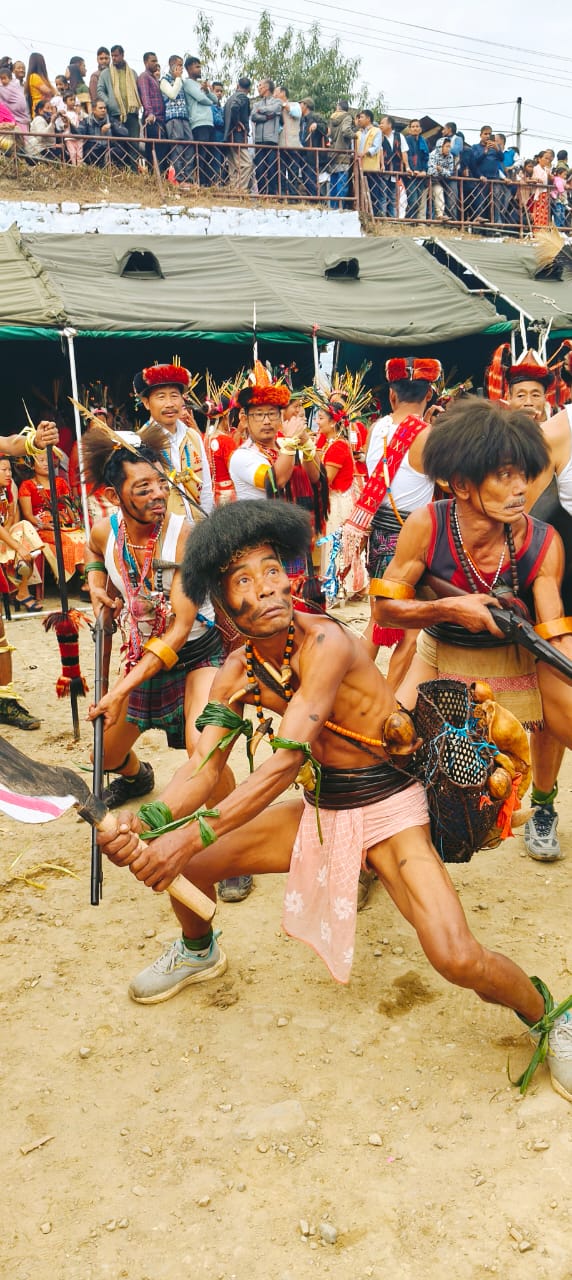Nocte warrior in mid-dance with traditional weapons at Chalo Loku Festival