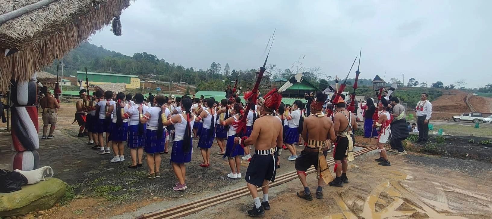 Konyak men raising spears and daos in the village festival ground during Aoleang in Mon district, Nagaland