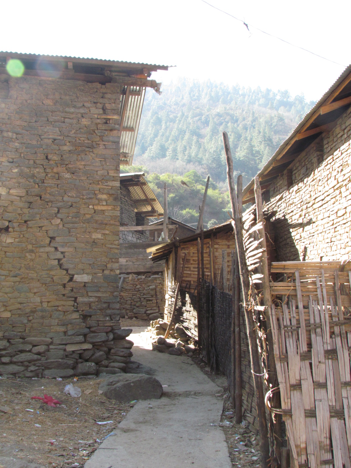 Narrow stone-paved lane between dry-stone and bamboo houses in Thembang, a fortified Monpa village in West Kameng, Arunachal Pradesh