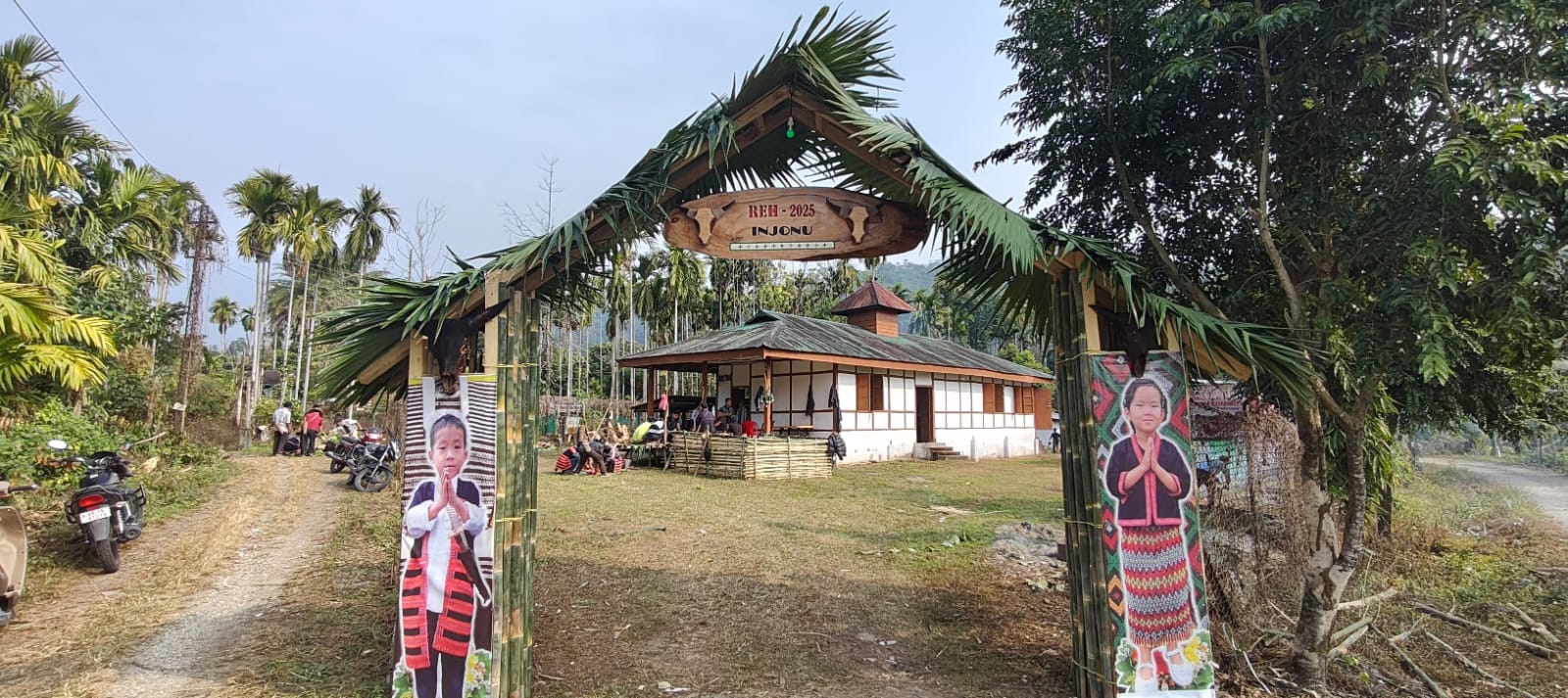 Festival gateway marking Reh 2025 at Injonu, with traditional Idu Mishmi portraits flanking the bamboo entrance