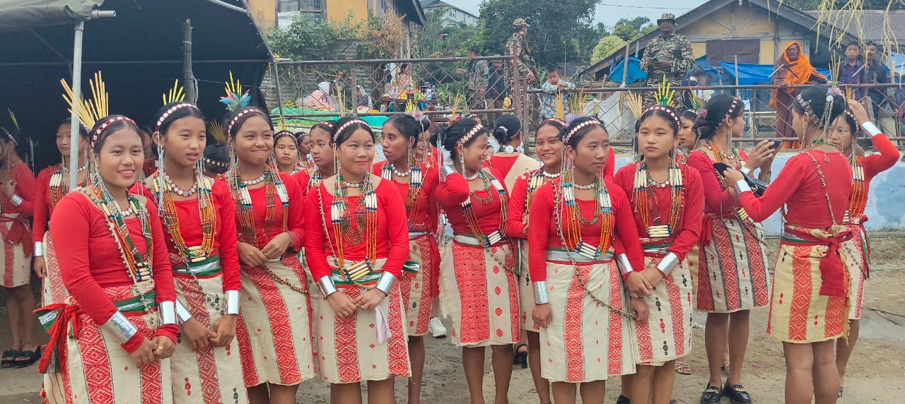 Nocte young women in traditional red and cream dress with bead necklaces, Chalo Loku