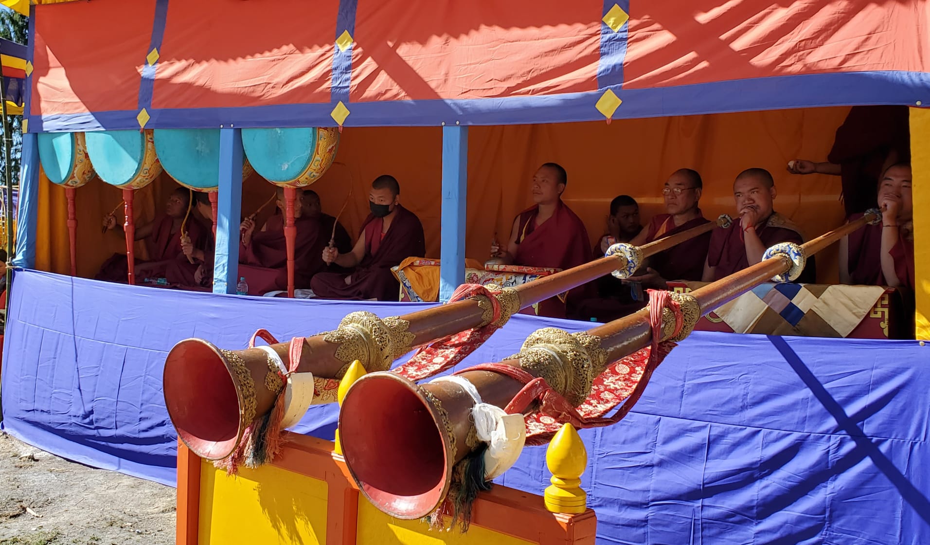 Monks playing Tibetan dungchen long horns during Losar Festival rituals, Tawang Monastery, Arunachal Pradesh