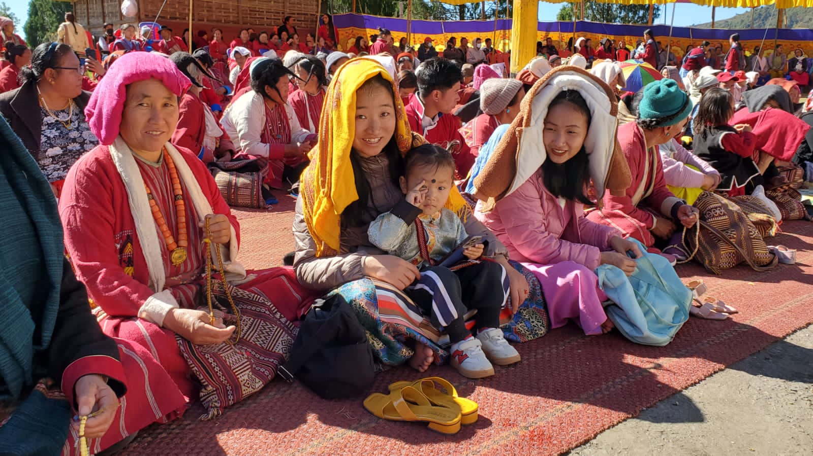 Monpa women devotees in traditional headscarves with prayer beads during Losar Festival, Tawang