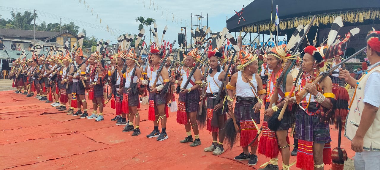 Long line of Nocte warriors with feathered headdresses at Chalo Loku Festival ground